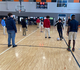Students in gym playing ball