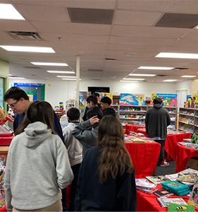 Students attending a book fair in the school library